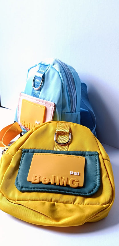Two cute backpacks for dogs in yellow and blue, displayed on a white surface, representing our diverse collection of dog apparel and pet clothes.