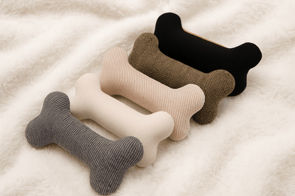 A collection of five plush nooking bones in various modern colours and fabrics, laid out on a soft blanket as the perfect dog nooking toy.